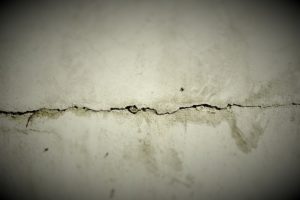 extensive crack in a slab foundation that is leaking water
