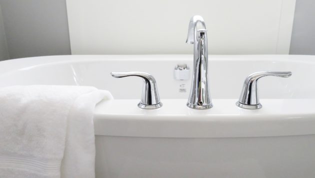 a close-up view of a bathtub with a towel on the side