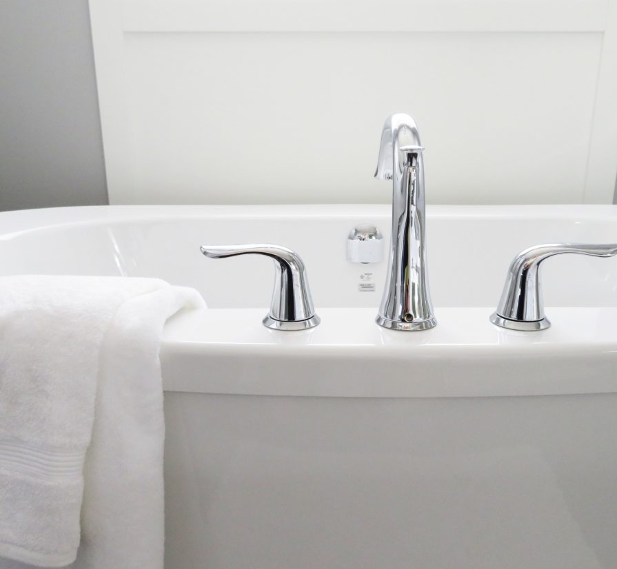 a close-up view of a bathtub with a towel on the side