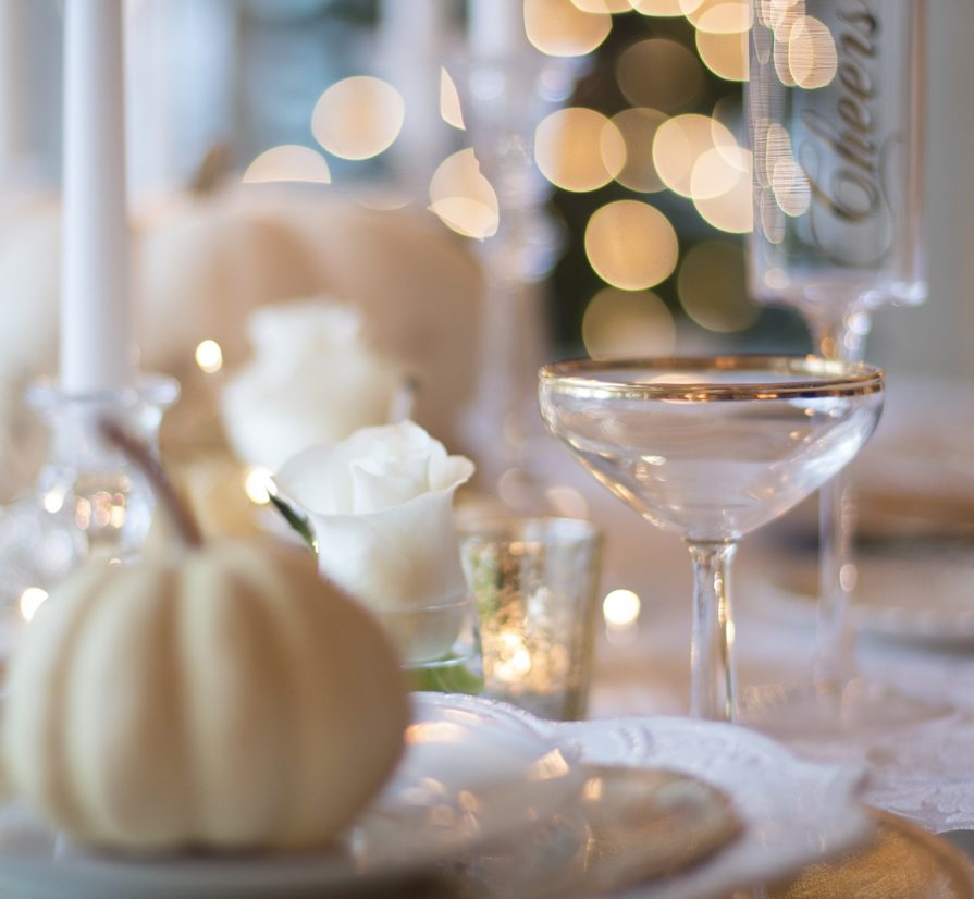 a table set with dishes and decorations for Thanksgiving