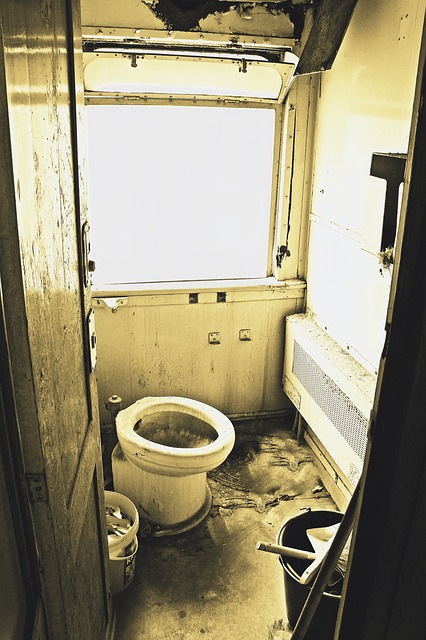 a filthy bathroom with dirty walls and a broken toilet