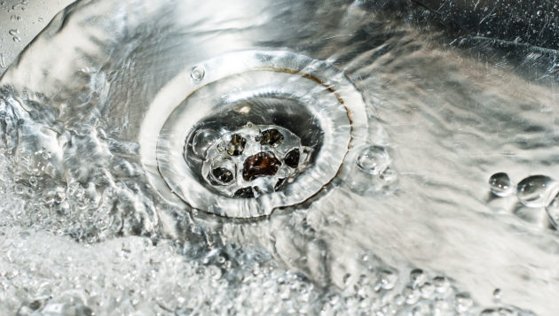 water draining steadily down a kitchen sink