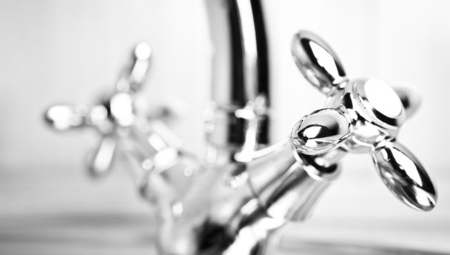 a close-up of silver handles to a sink