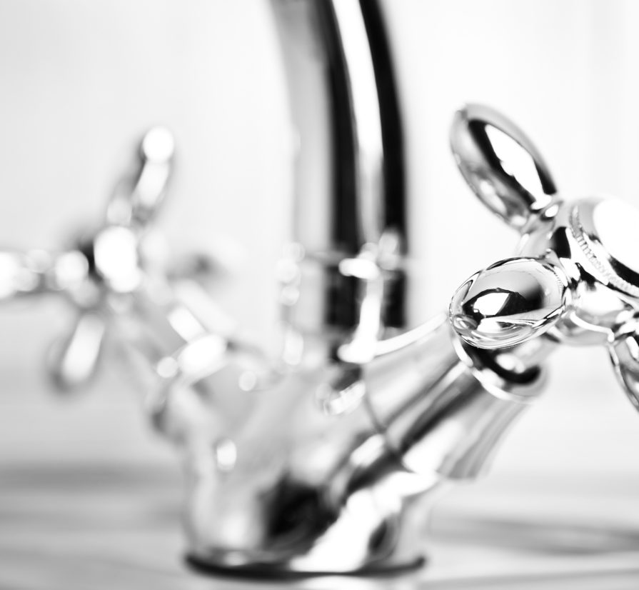 a close-up of silver handles to a sink