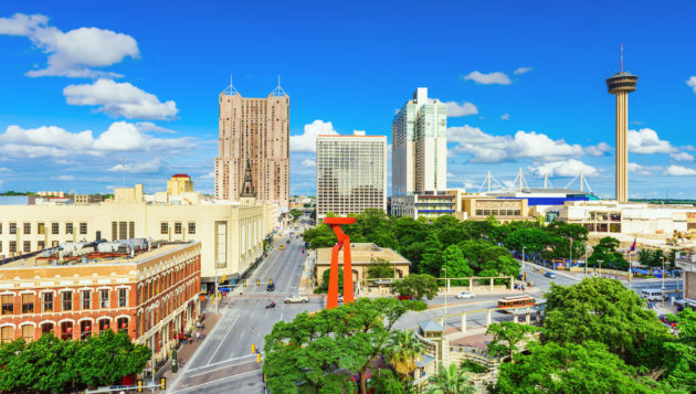 a view of downtown San Antonio with roads and tall buildings visible