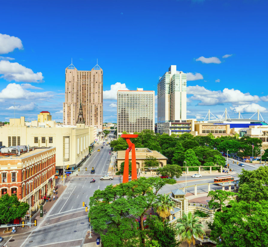 a view of downtown San Antonio with roads and tall buildings visible