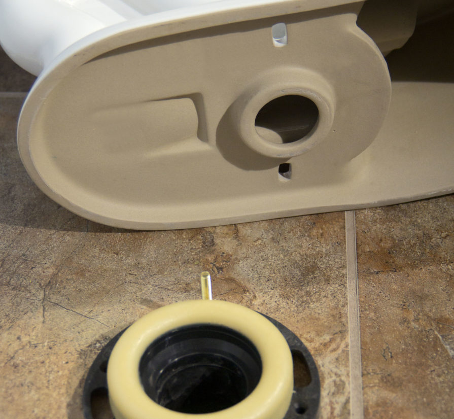 parts for a toilet installation on a bathroom floor in Shavano Park