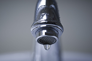 sink faucet dripping water due to a leak