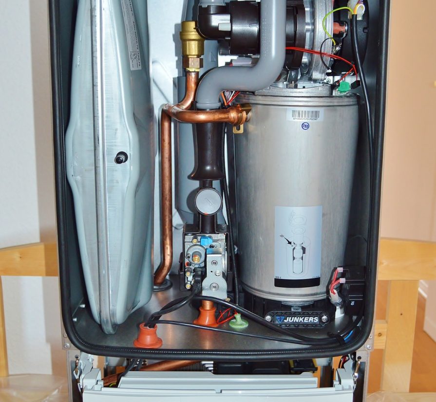 the inside of a water heater opened up to expose internal system parts