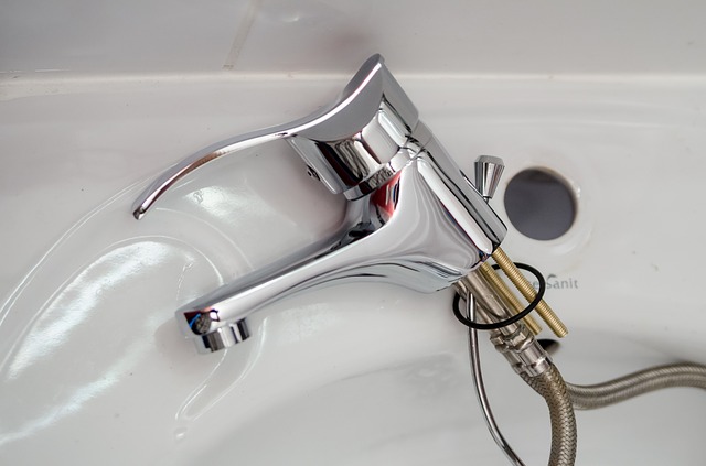 the faucet of a sink pulled out and laying on its side in a converse bathroom