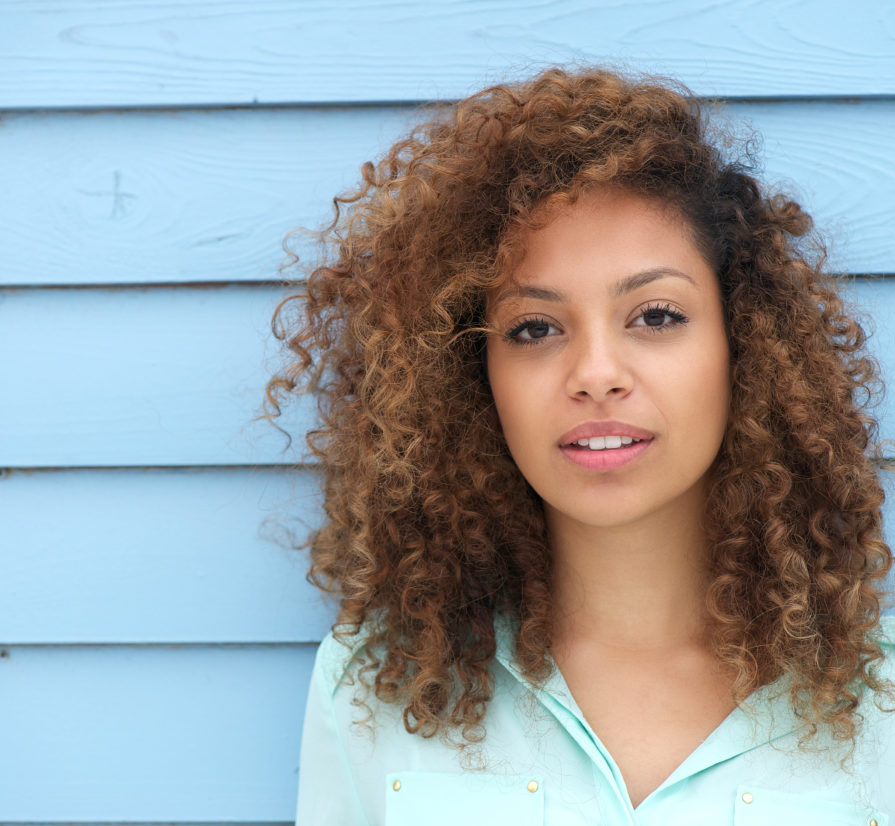 woman posing against the wall of a San Antonio home