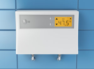 a tankless water heater installed on a wall with its temperature settings displayed