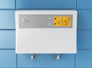 a tankless water heater installed on a wall with its temperature settings displayed