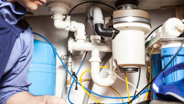a new braunfuels plumber examining an intricate plumbing system