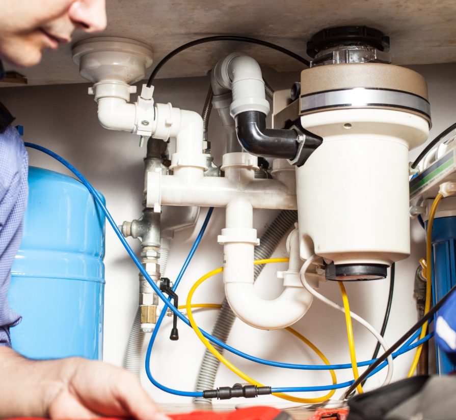a new braunfuels plumber examining an intricate plumbing system