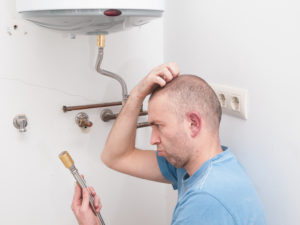 a confused man trying to install a water heater