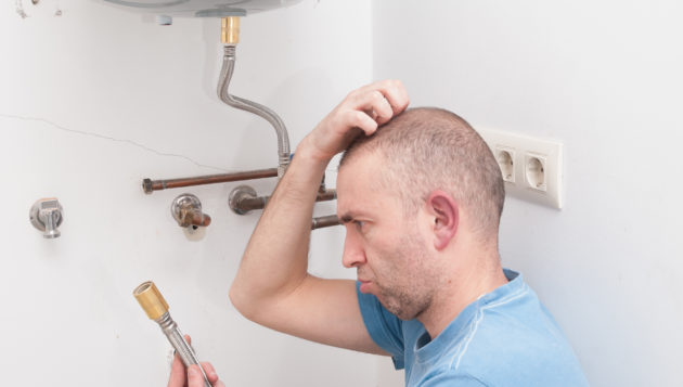 a confused man trying to install a water heater