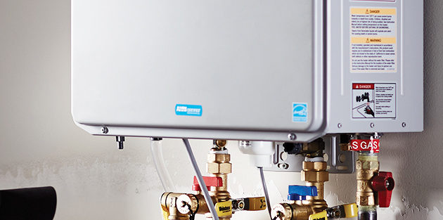 a silver tankless water heater installed on the wall of a home