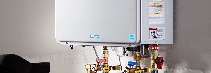 a silver tankless water heater installed on the wall of a home