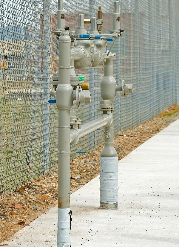 Pipes outside fence