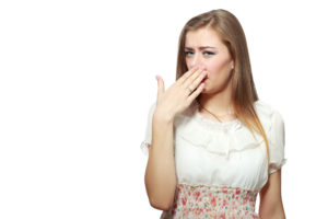 woman covering her face to block a bad smell
