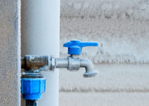 an outdoor plumbing system that has frozen over during the winter