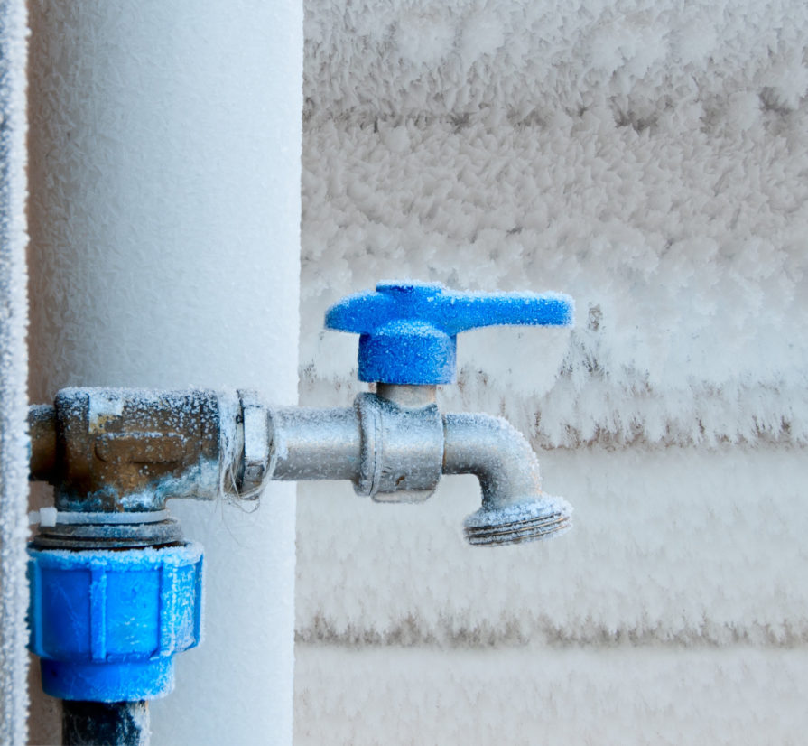an outdoor plumbing system that has frozen over during the winter