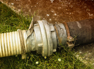 a damaged sewer line laying in the yard of a San Antonio home