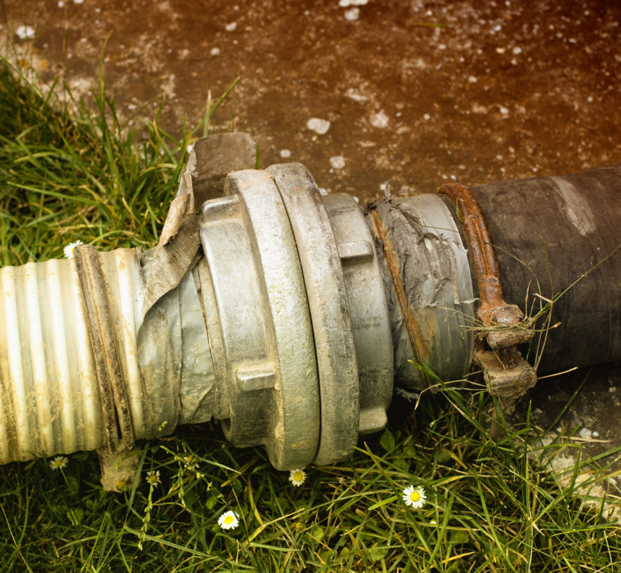 a damaged sewer line laying in the yard of a San Antonio home