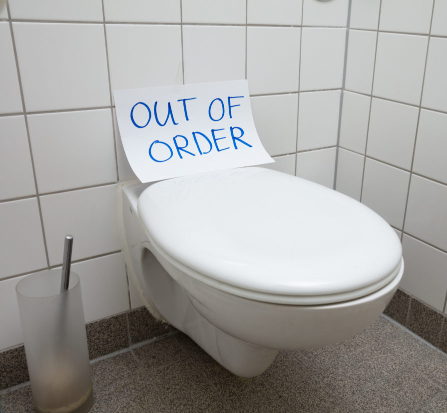 a toilet with an out of order sign on it