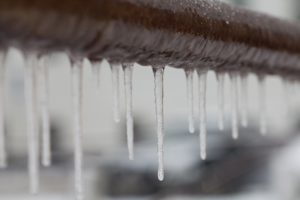 ice hanging off of a pipe during winter
