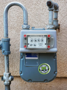 residential gas meter installed on the side of a wall