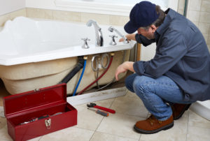 a professional plumber installing a bathtub for a San Antonio home