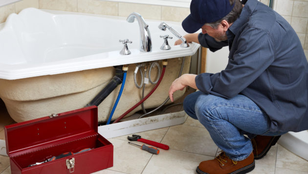 a professional plumber installing a bathtub for a San Antonio home