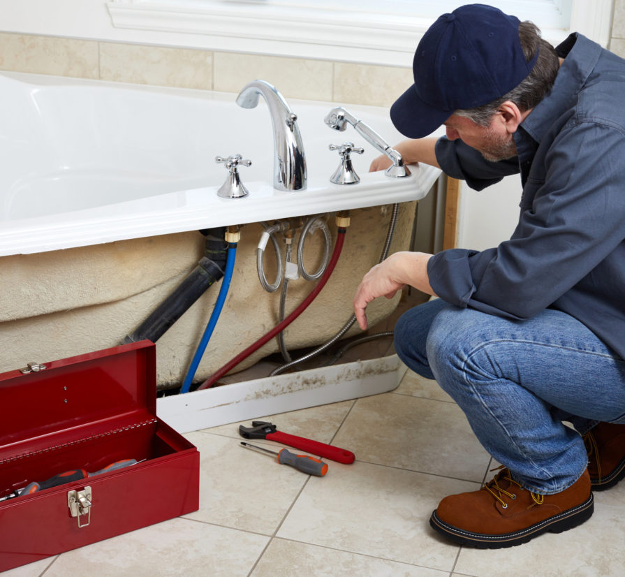 a professional plumber installing a bathtub for a San Antonio home
