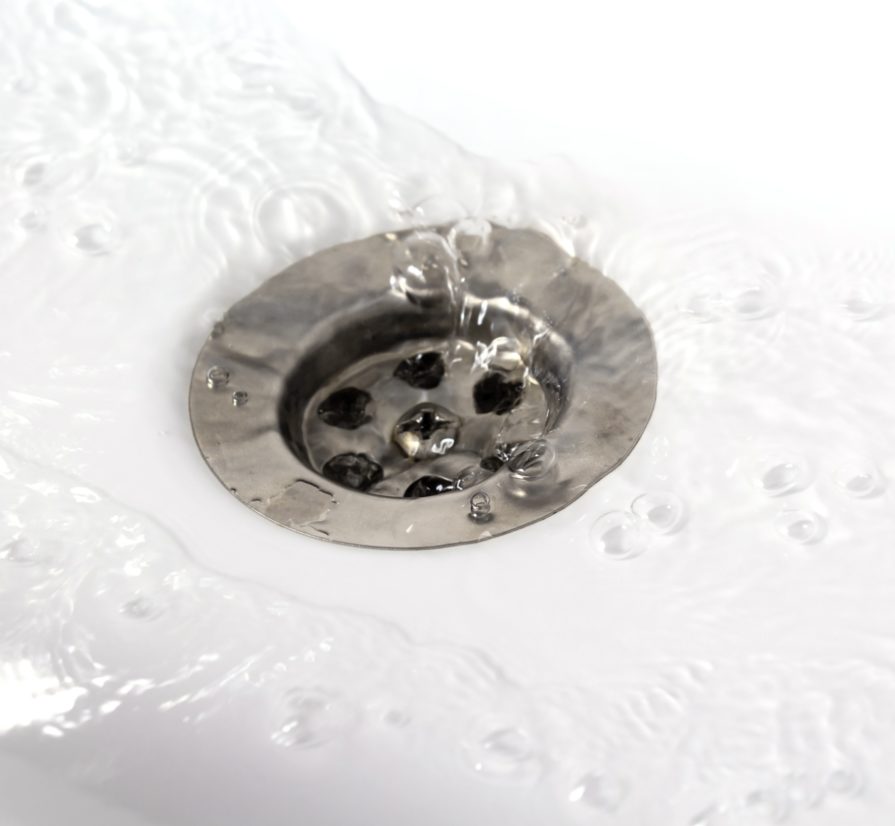 water flowing into a drain in a Seguin sink